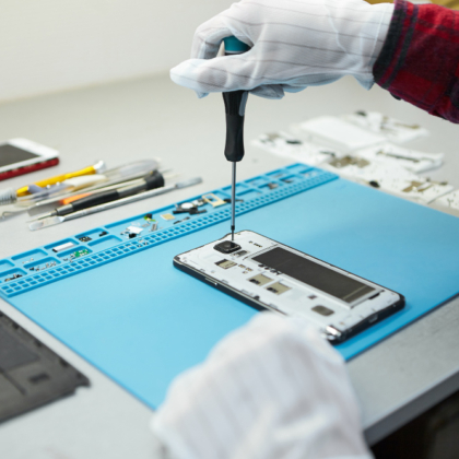 technician-antistatic-gloves-using-screwdriver-disassemble-borken-mobile-phone-going-repair-motherboard-sitting-his-workplace-laboratory-with-needed-equipment